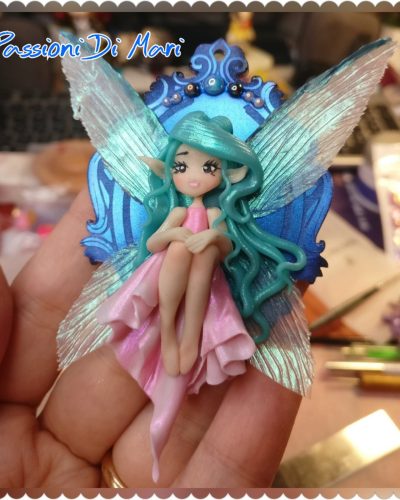 Little Fairy sitting on a shiny cameo frame handmade polymer clay, fimo