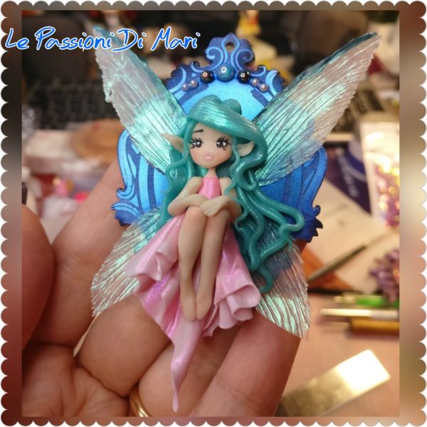 Little Fairy sitting on a shiny cameo frame handmade polymer clay, fimo